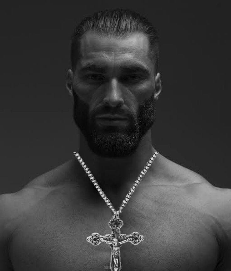 Muscular man with beard and silver crucifix necklace.