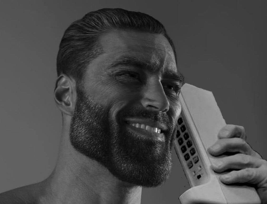 Confident man smiling while holding a vintage telephone.