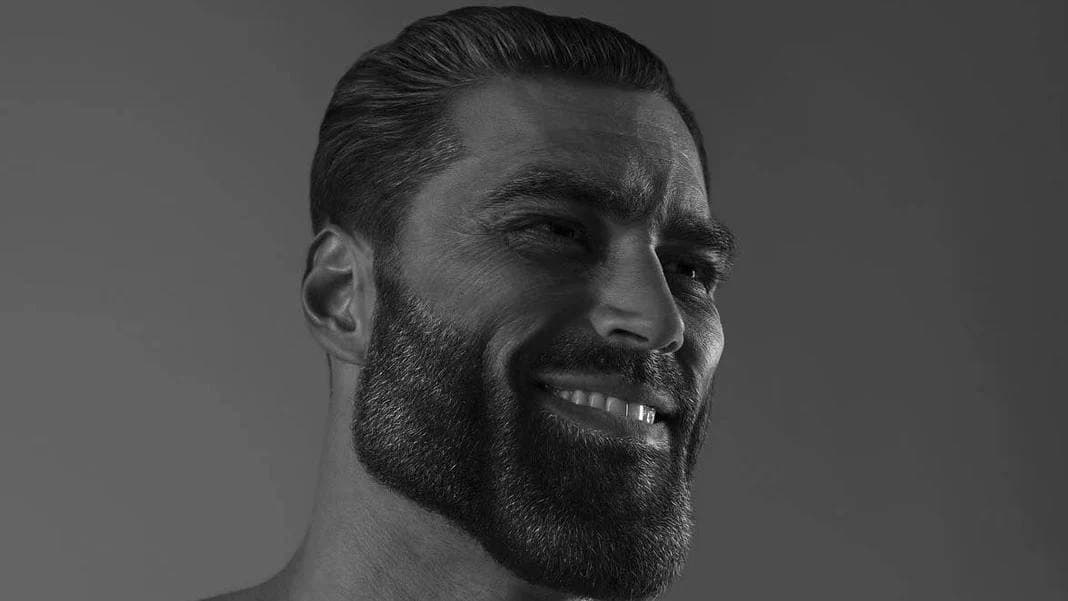 Muscular man with a chiseled jawline smiling confidently.