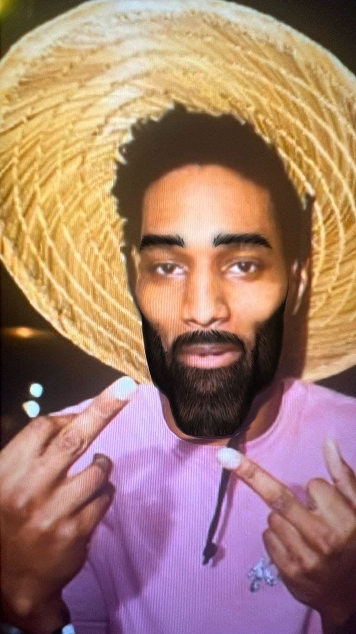 Man in straw hat making a double middle finger gesture.
