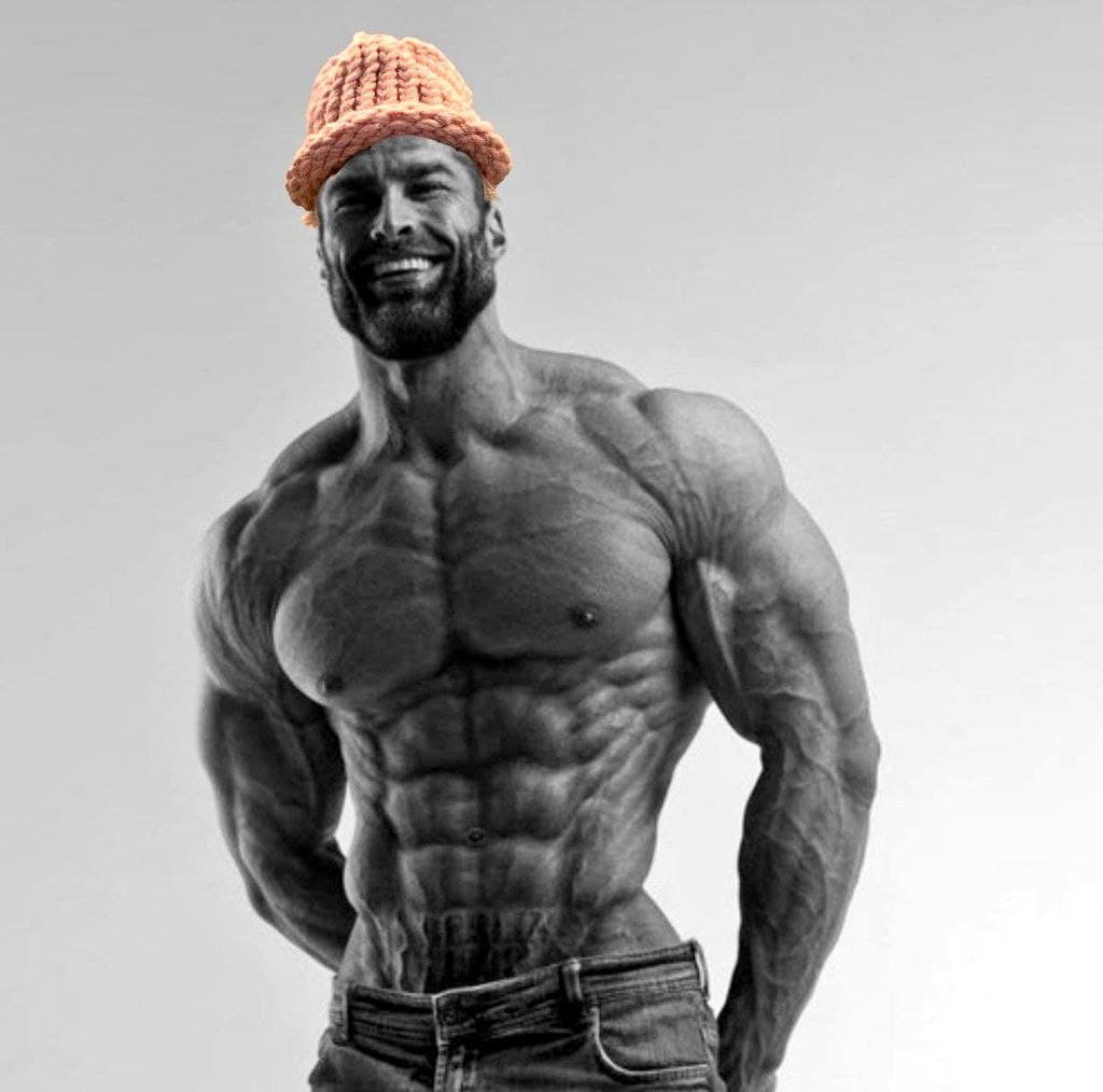 Muscular man smiling with a knitted hat.