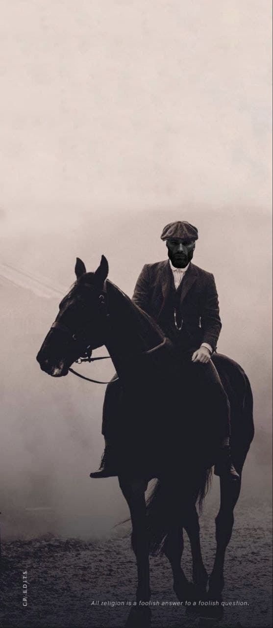 A man on a horse in a foggy setting.