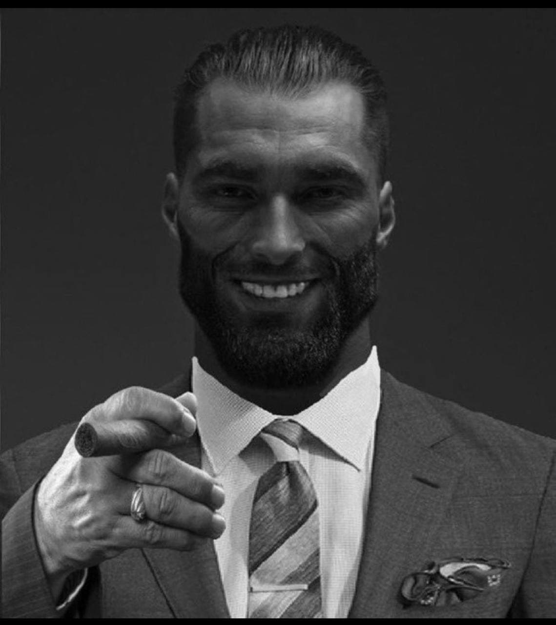Confident man in suit smiling with a cigar.