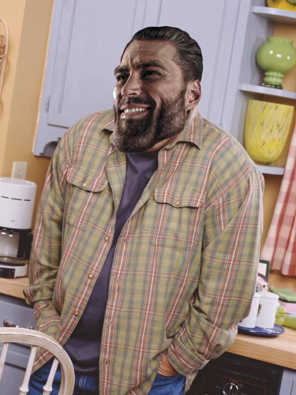 Muscular man with an imposing face in a kitchen.
