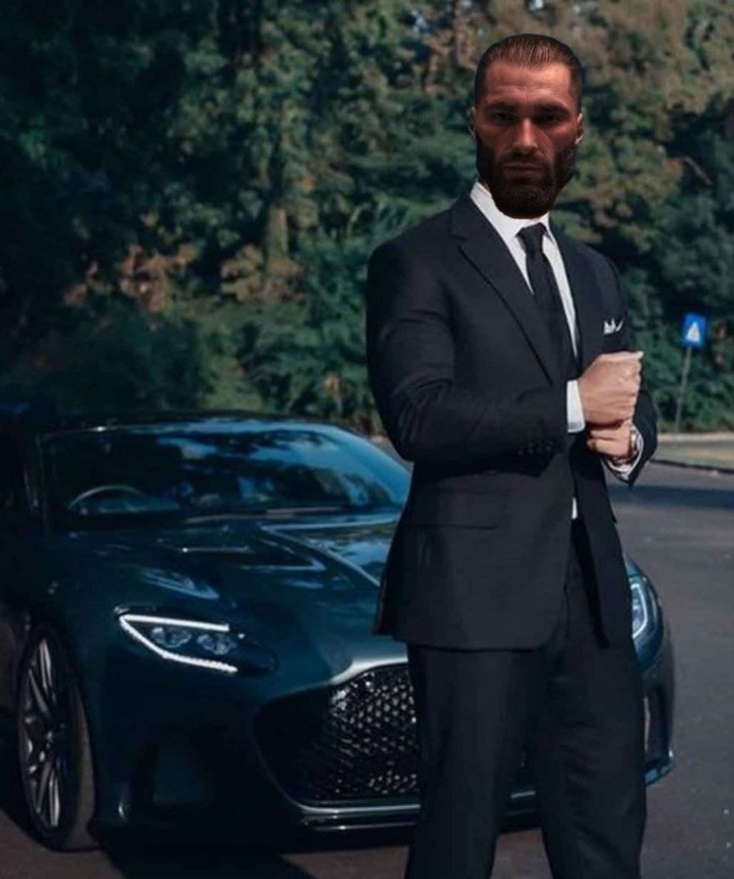 Man in suit stands confidently by a luxury car.