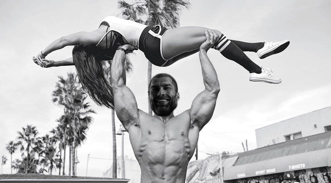 Strong man lifts woman, showcasing strength and confidence.
