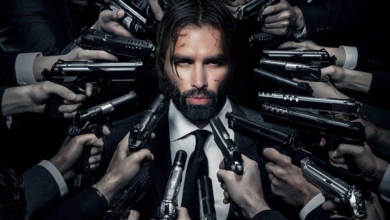 Man in suit surrounded by guns, showing confidence.