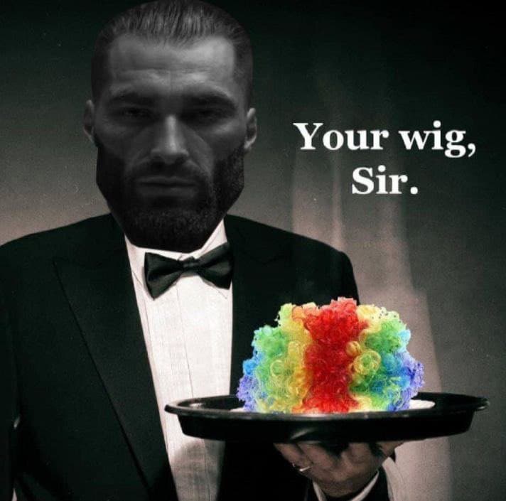 A man in a tuxedo presenting a colorful dessert wig.
