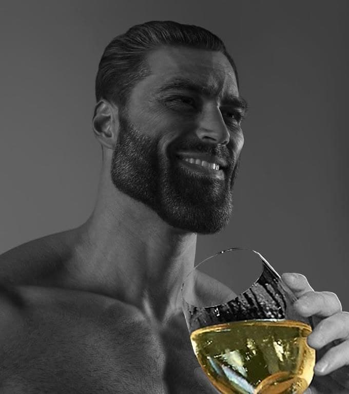 Muscular man smiling with a beer in hand.