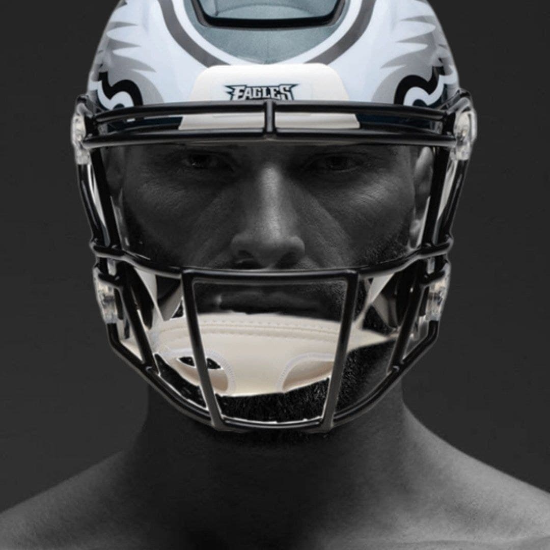 Muscular man in a football helmet, looking fierce and confident.