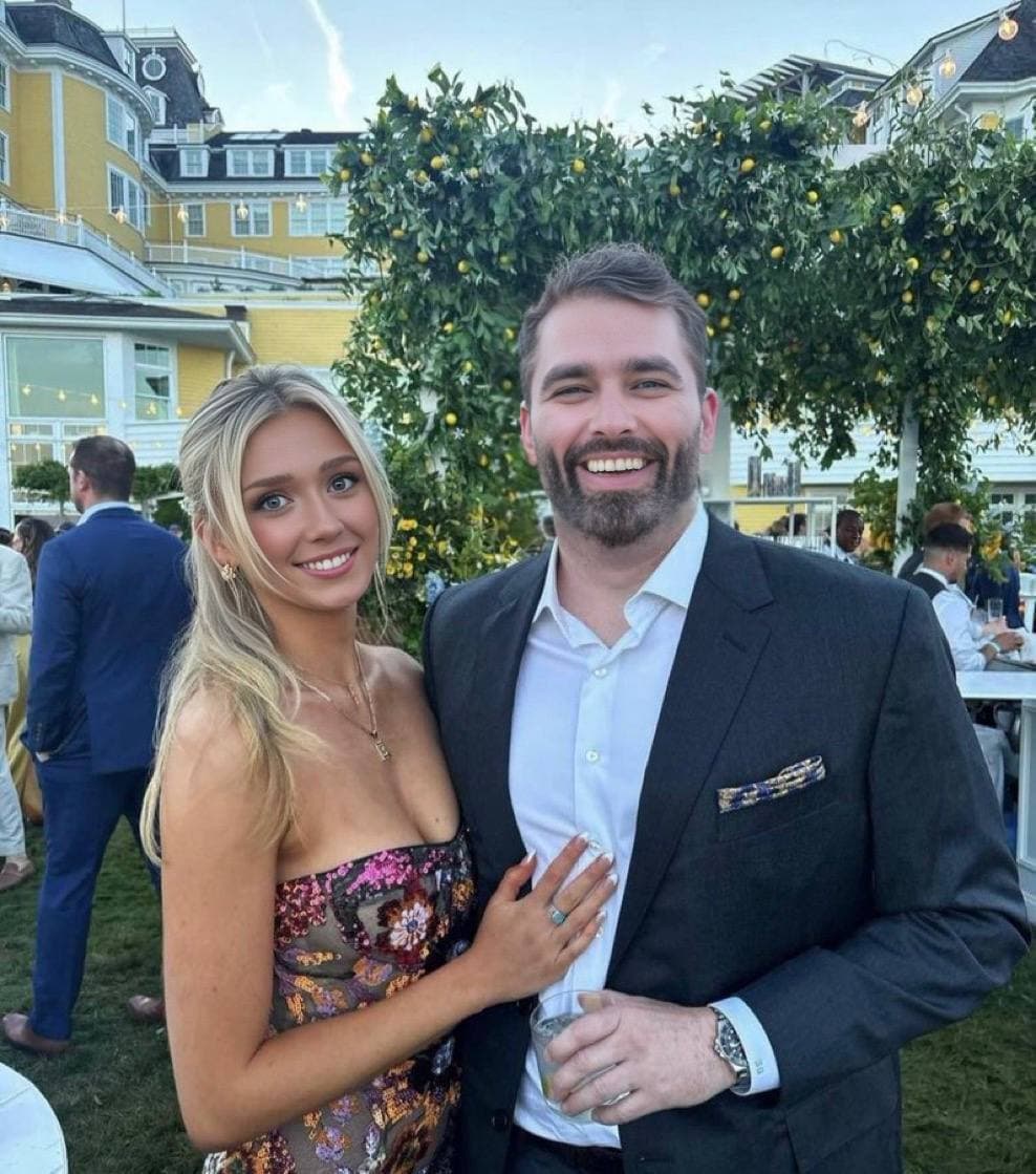 Happy couple posing at a festive outdoor event.