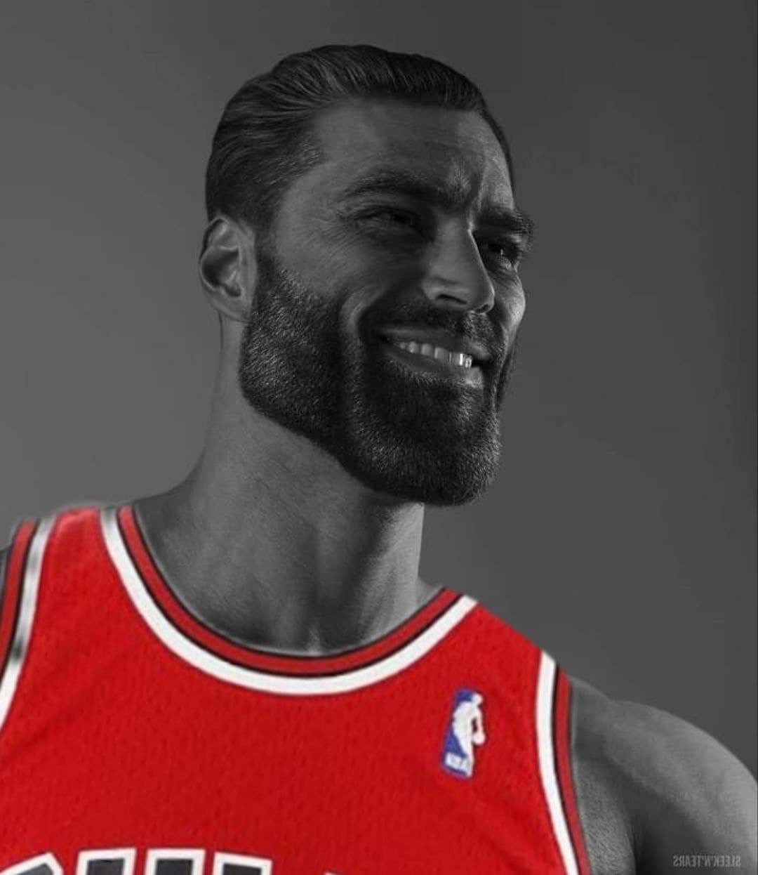 Muscular man in a red basketball jersey smiling confidently.