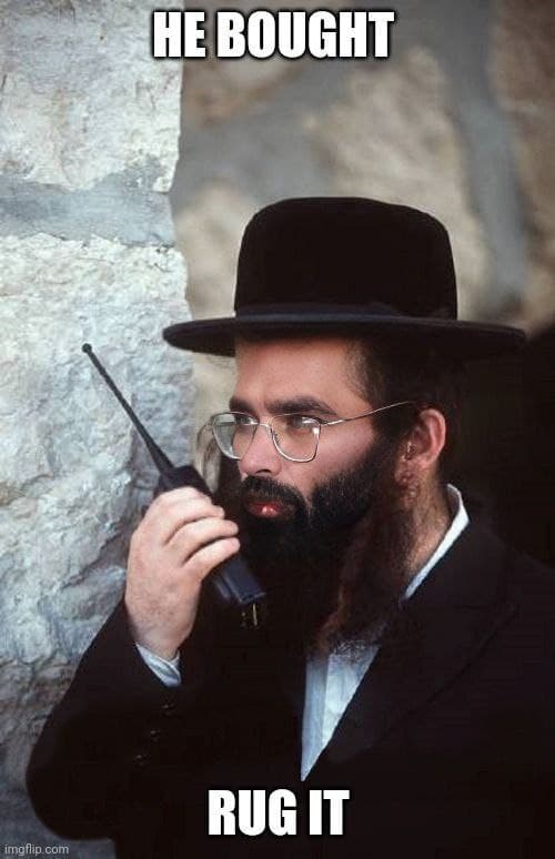 A man in traditional dress speaks into a radio communicator.