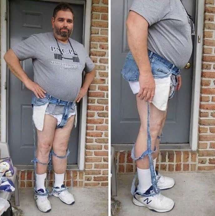 Man humorously poses in a bizarre denim outfit.