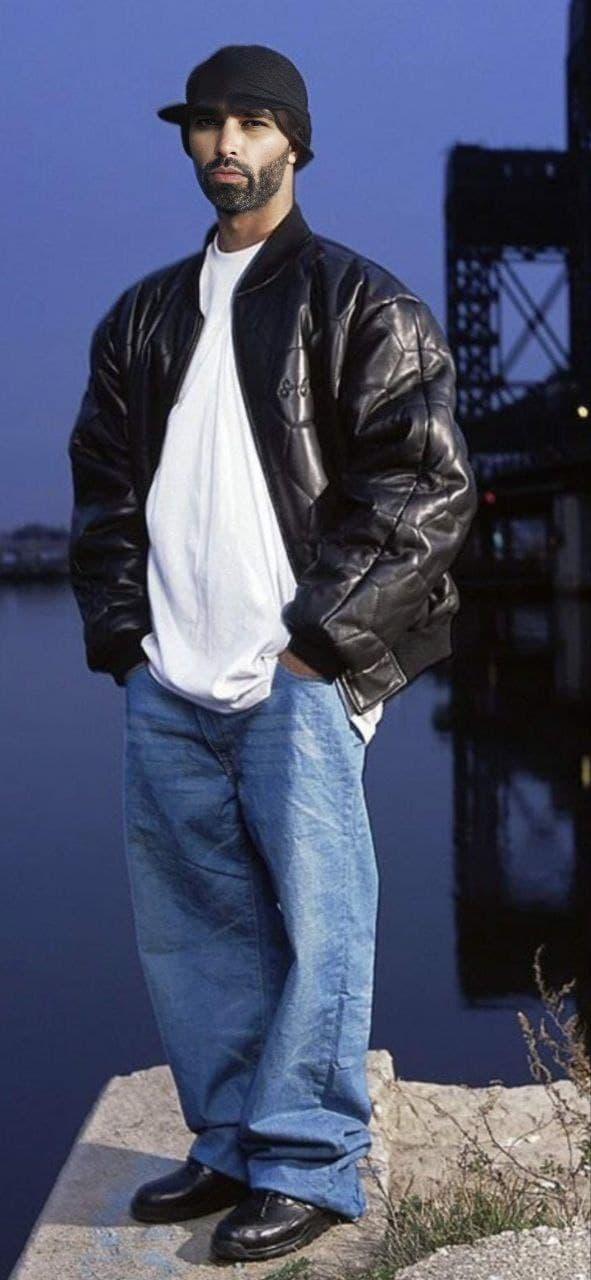 Confident man in a leather jacket by the water.
