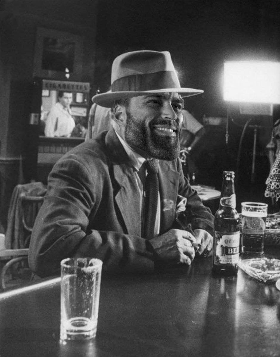 Man with GigaChad face seated at a bar.