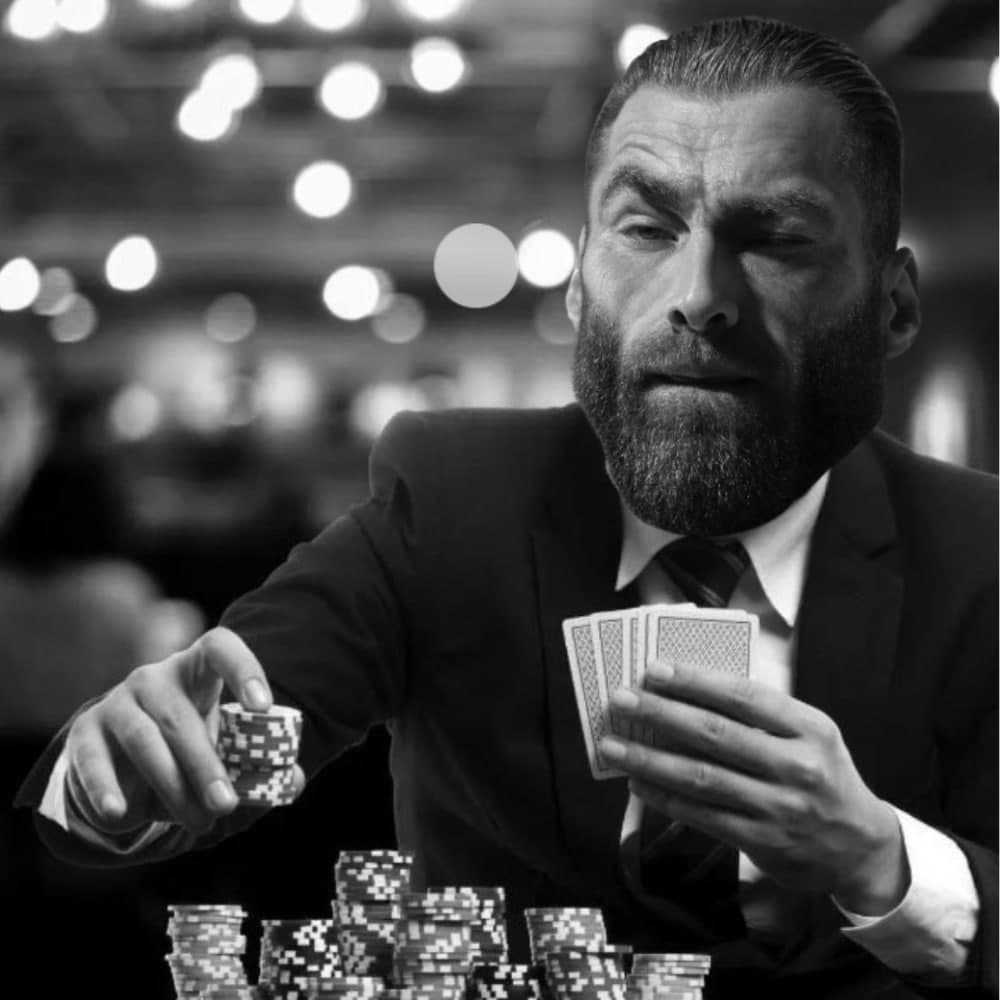 Confident man in a suit playing poker with chips.