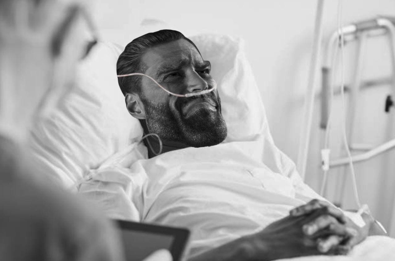 Muscular man in hospital bed displaying confidence despite setting.