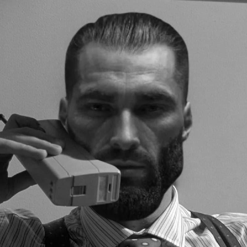 Muscular man in a suit holding a retro phone.