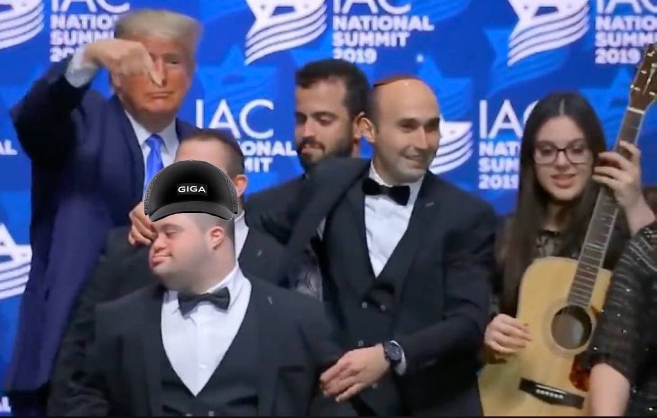 A man with Down syndrome sporting a GigaChad hat at a gathering.