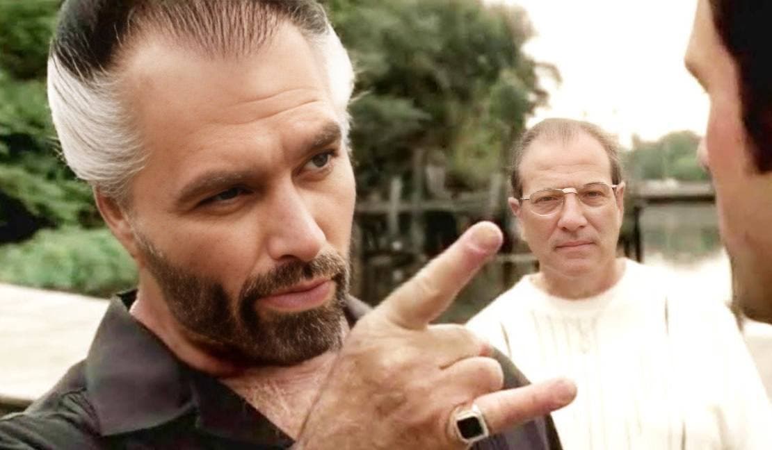 Confident man gestures as another watches, looking confused.