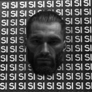 Intense man with a strong jaw against 'SI' background.