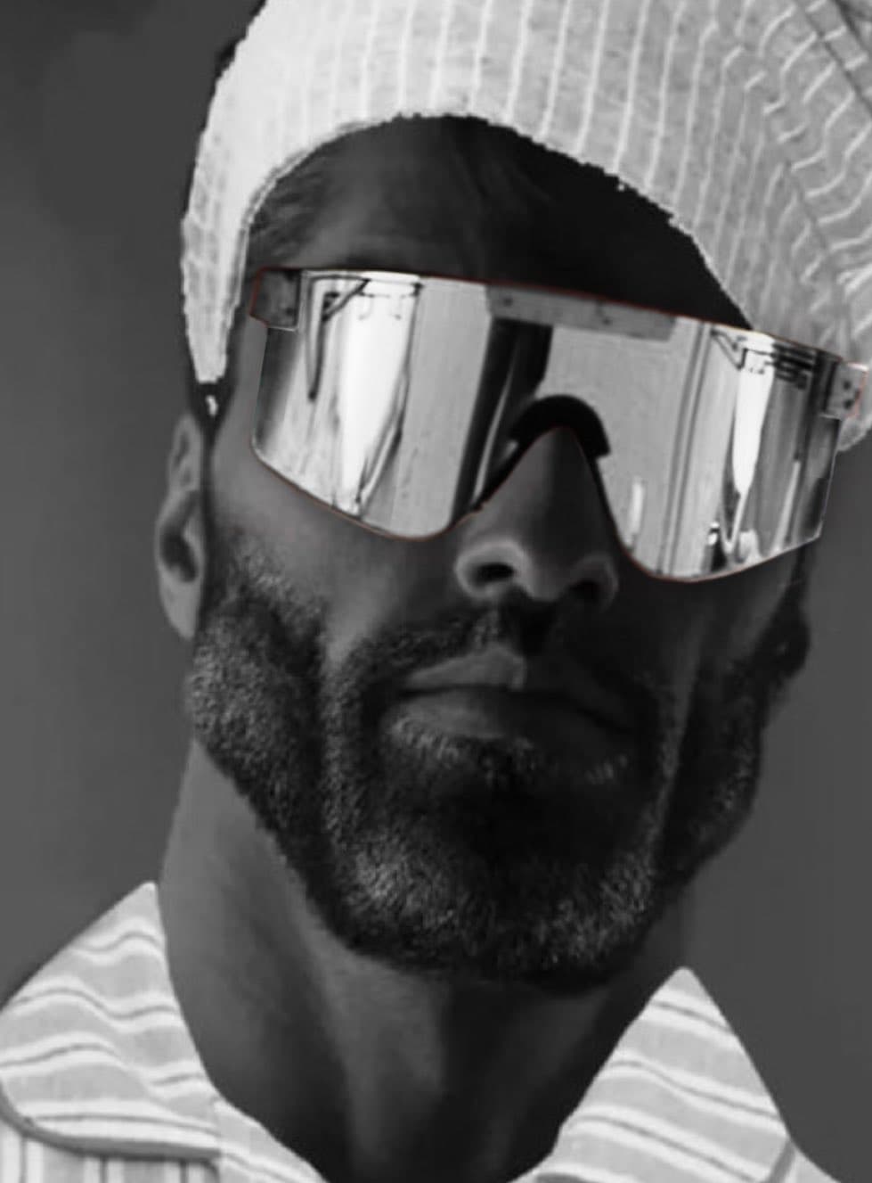 Muscular man in sunglasses and headband looking confident.