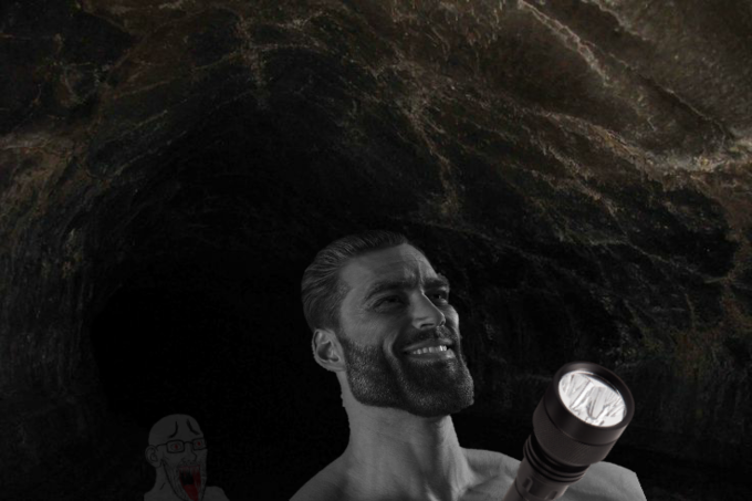 Confident man with flashlight in a dark cave, shadowy figure behind.