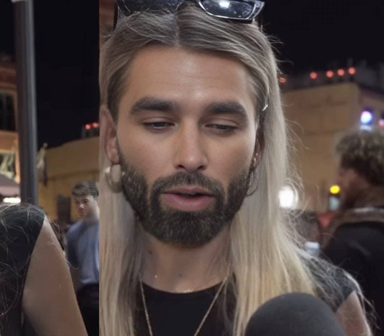 Close-up of a stylish young man with blonde hair and beard.