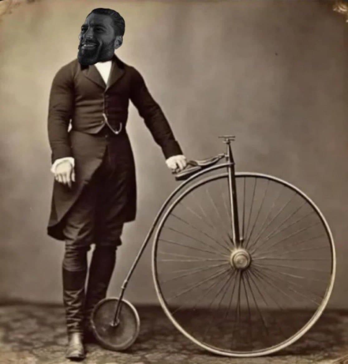 Man with GigaChad face next to vintage bicycle.