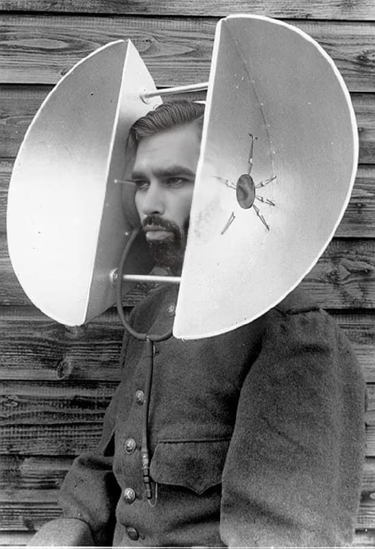 A man with speaker-like devices around his head.
