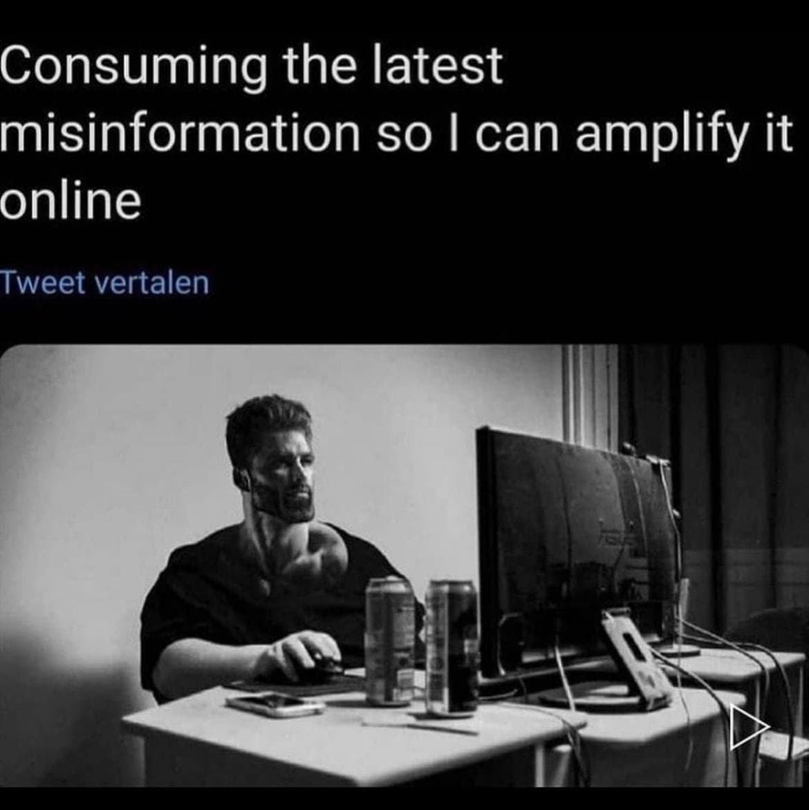 Muscular man consuming misinformation while at his computer.