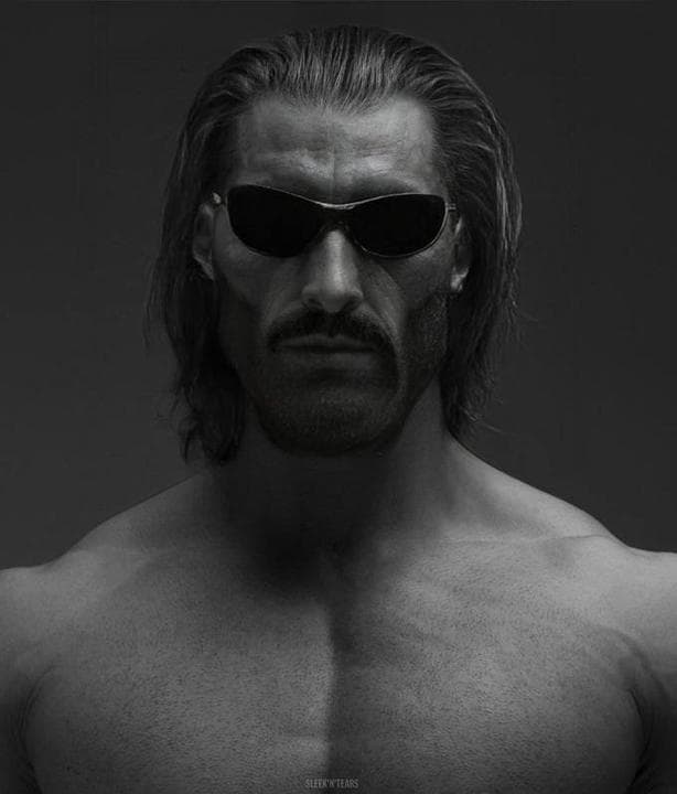 Muscular man in sunglasses with strong features against a dark background.