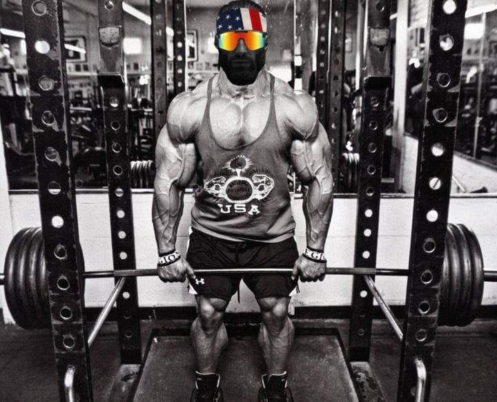 Muscular man lifting weights in a gym.