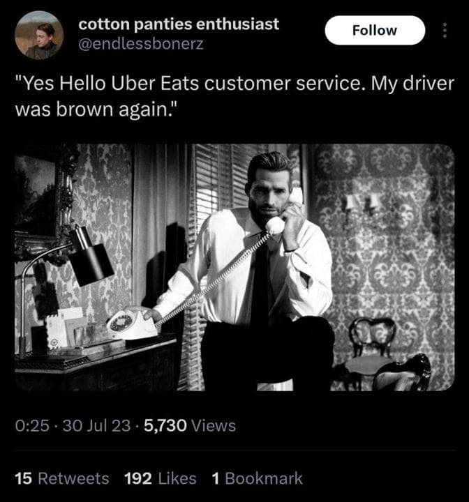 Man in suit on phone expressing Uber Eats complaint.