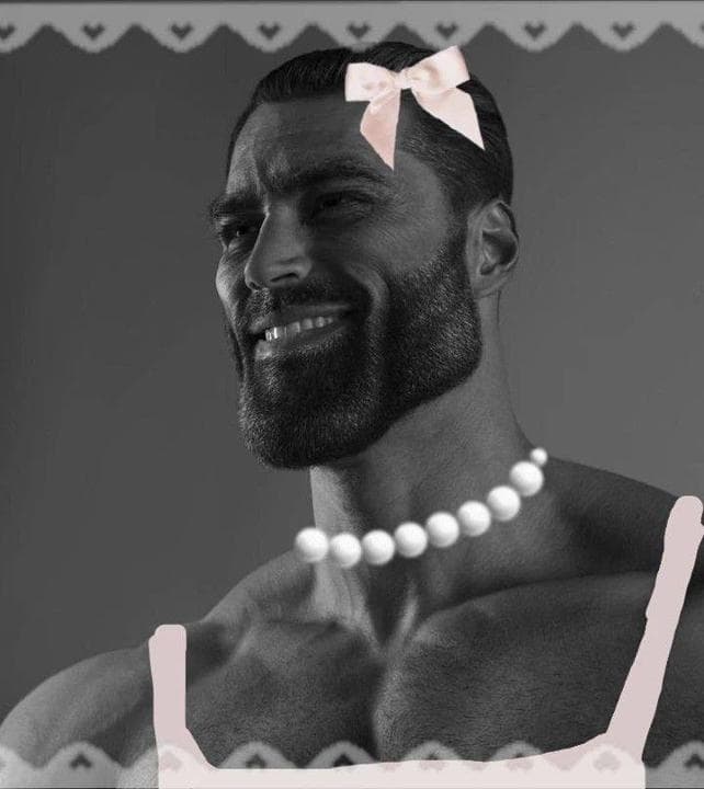 Muscular man in a pink bow and pearls smiling.