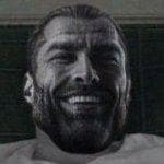 Muscular man smiling confidently against a simple background.