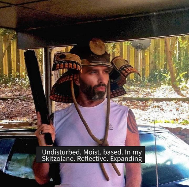 Muscular man in samurai helmet with a stick.