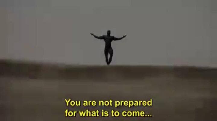 Silhouette figure with arms outstretched in a desolate landscape.